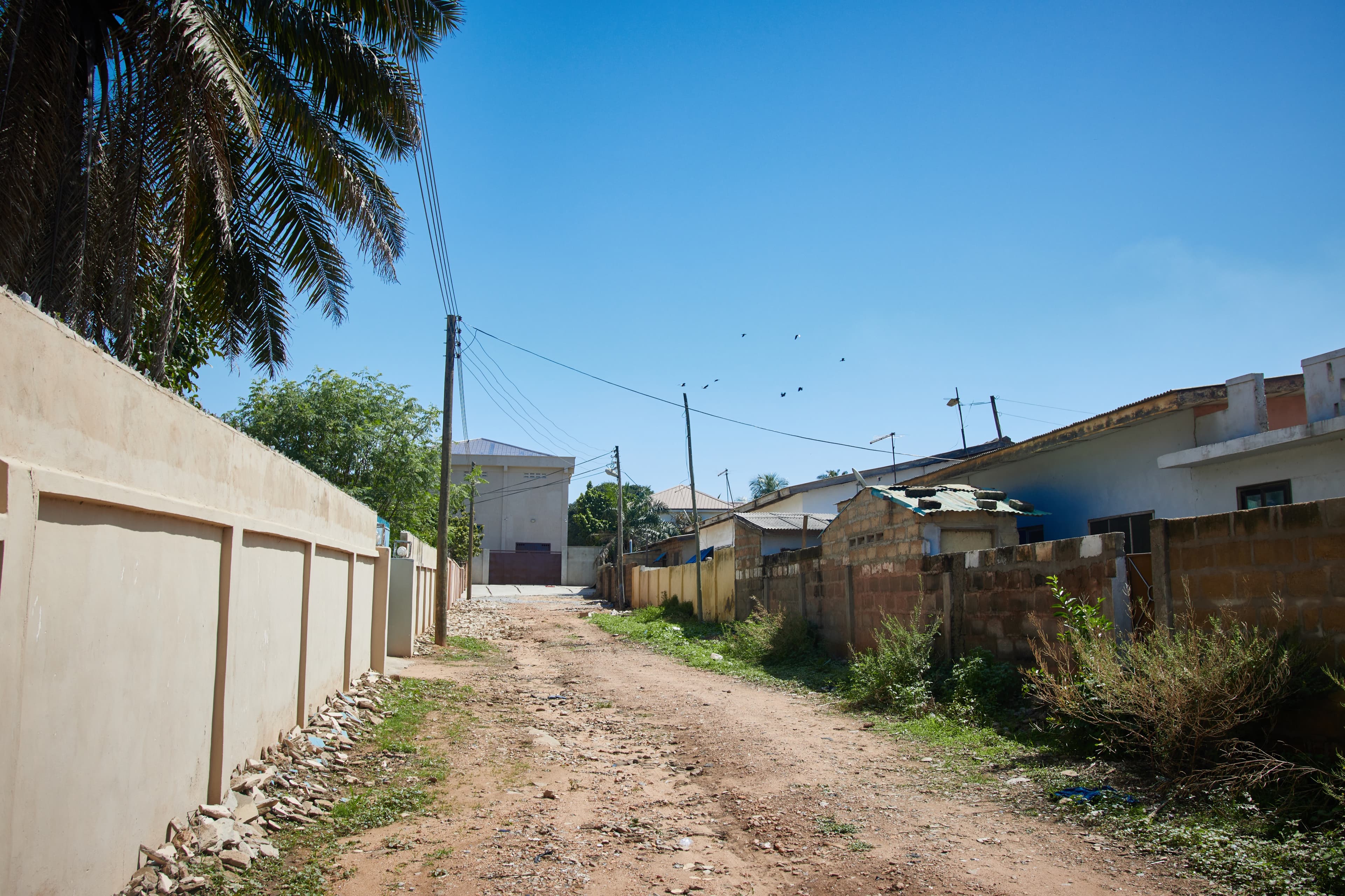 A view of a street with power lines overhead in Accra, Ghana.