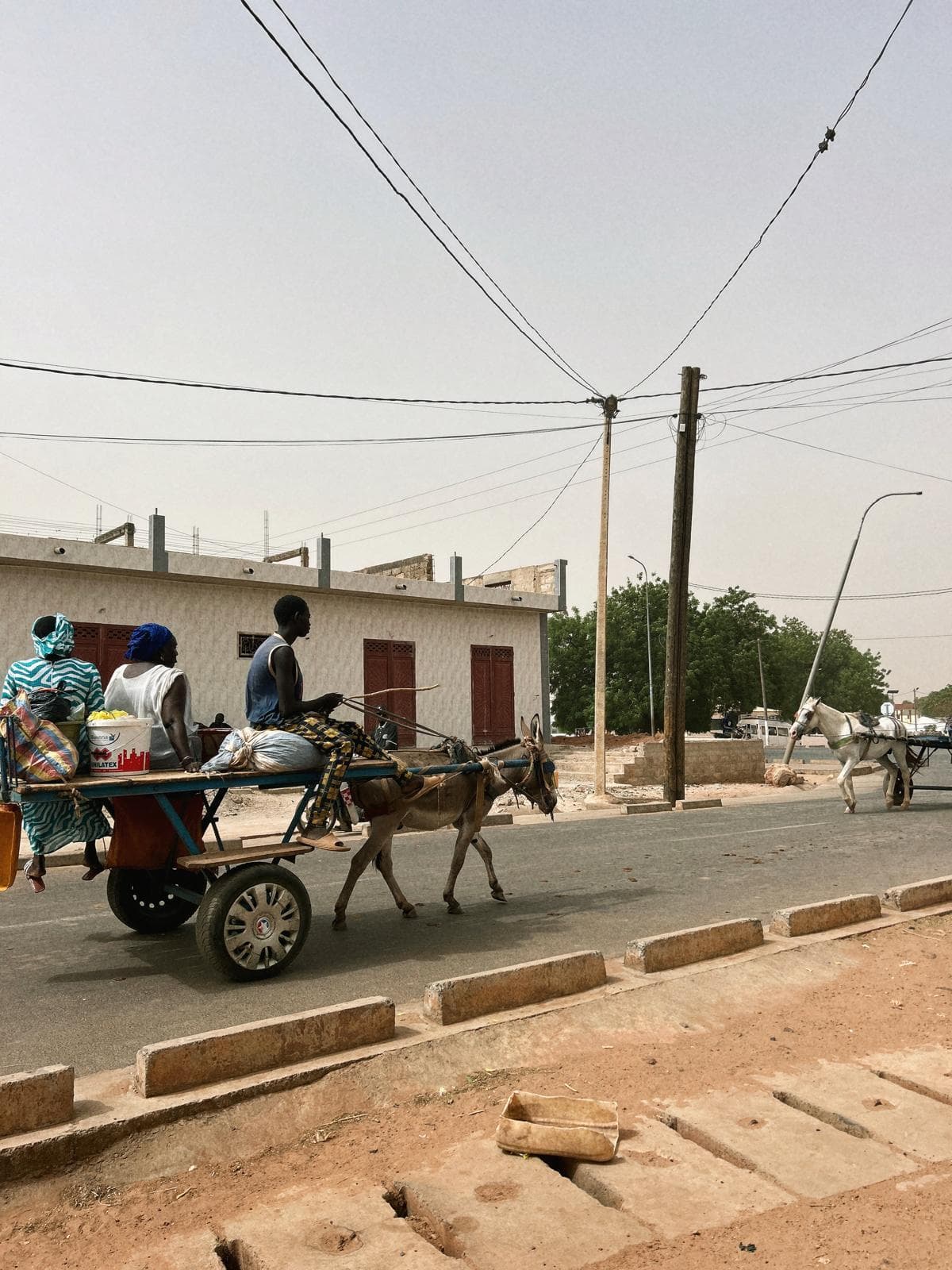 A view of a street with power lines overhead in Kaolack.