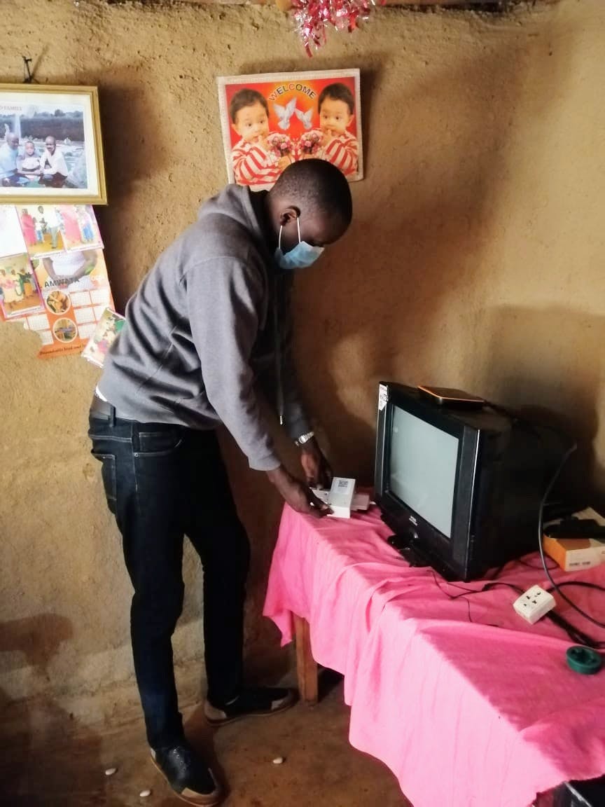 REMIT’s field enumerator installing a sensor with a household.